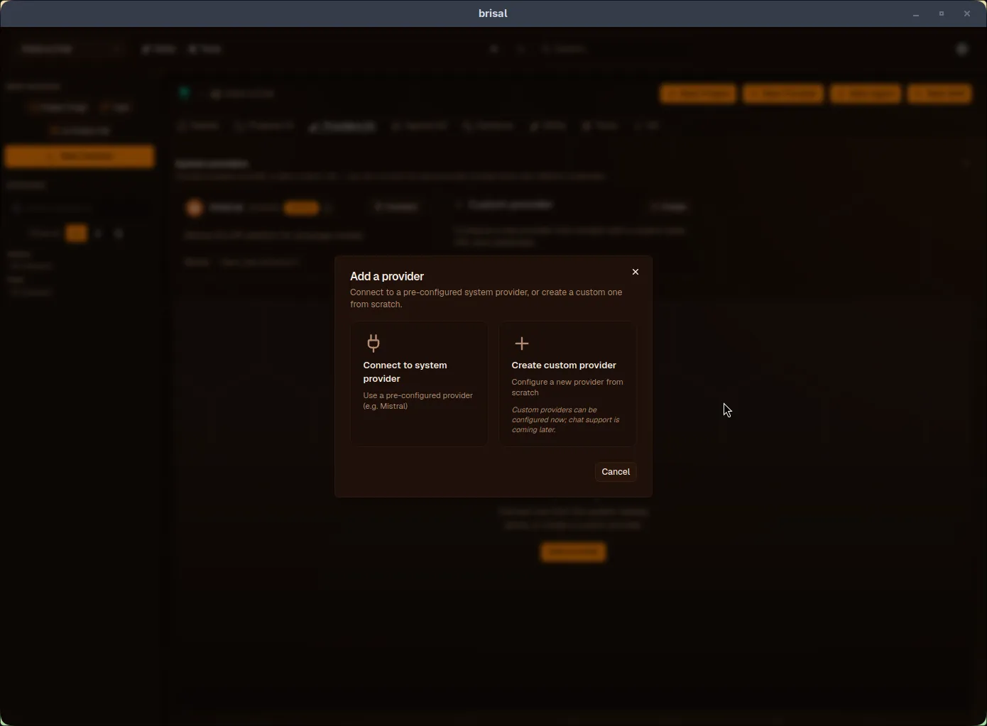 The "Add a provider" dialog with two large options side by side: "Connect to system provider — Use a pre-configured provider (e.g. Mistral)," and "Create custom provider — Configure a new provider from scratch." A Cancel button sits at the bottom.